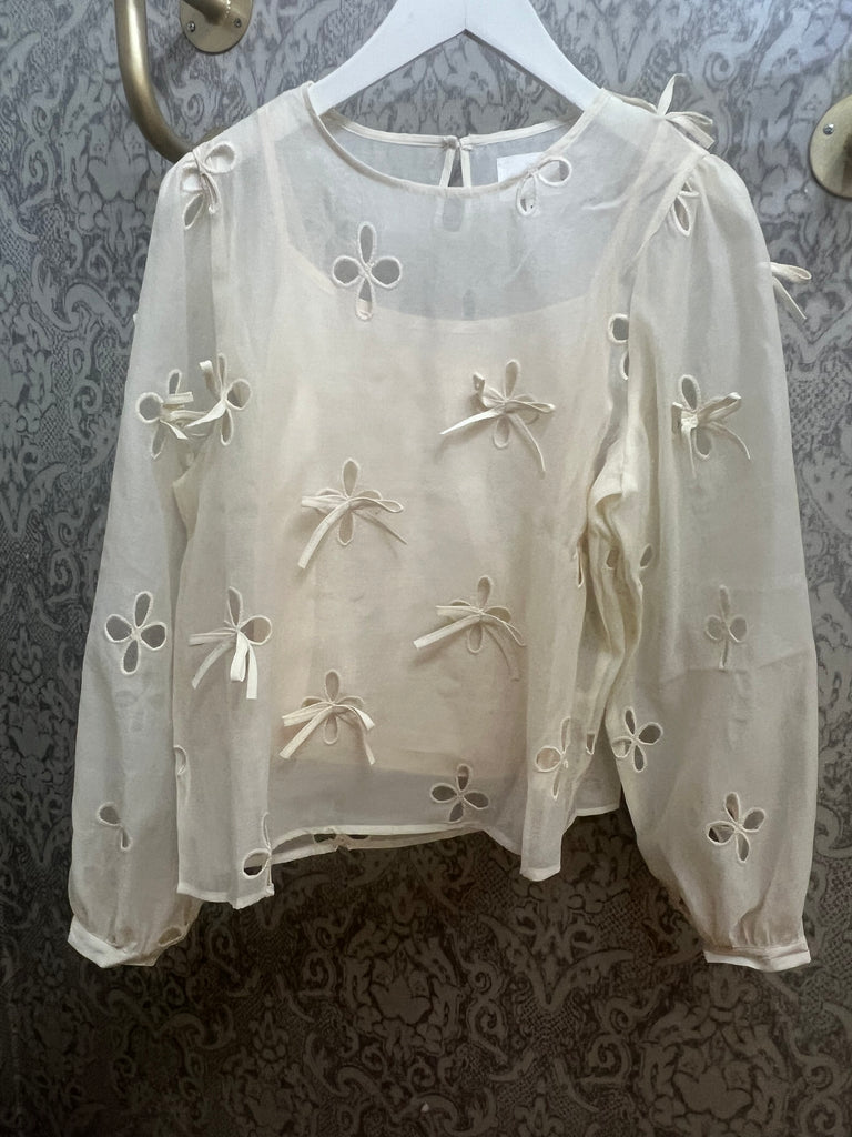 CREAM BOW TOP W CUTOUT DETAIL